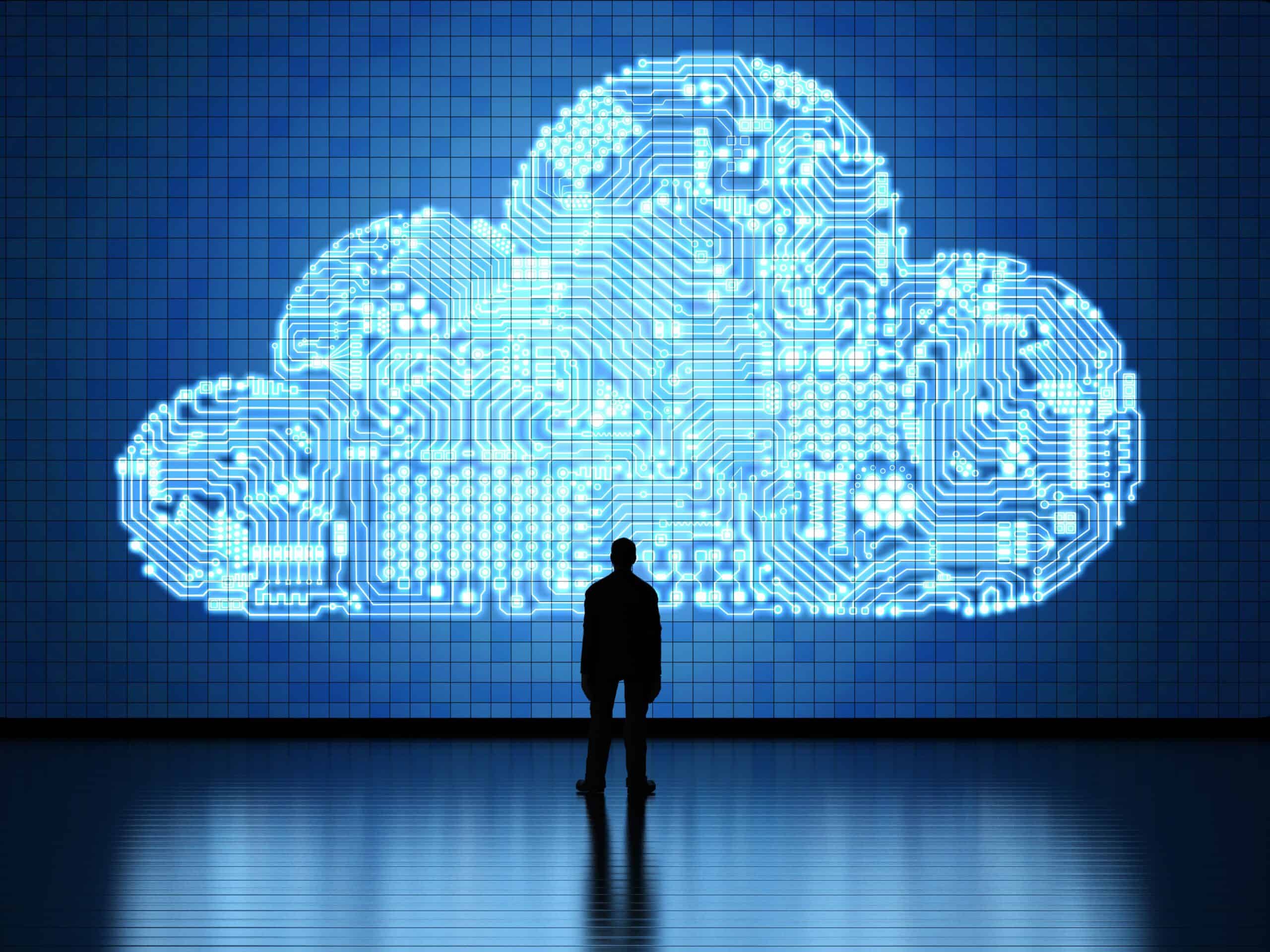 man-next-to-large-cloud-depicting-cloud-technology